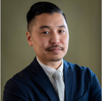 Photo of Superintendent Jon Sato in a blue suit in front of a green background.